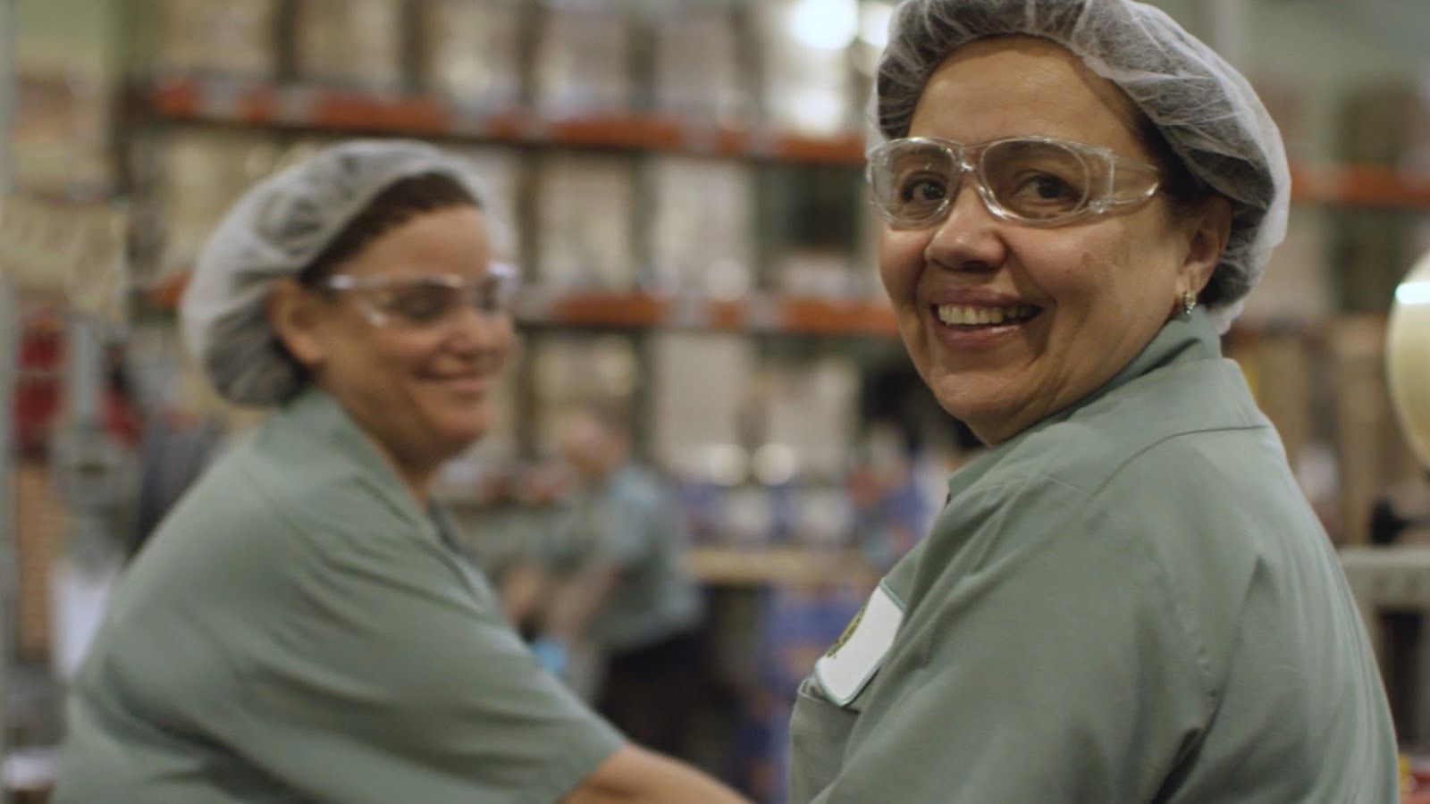 Two Women Packaging Earth Friendly Cleaning Products In A Warehouse