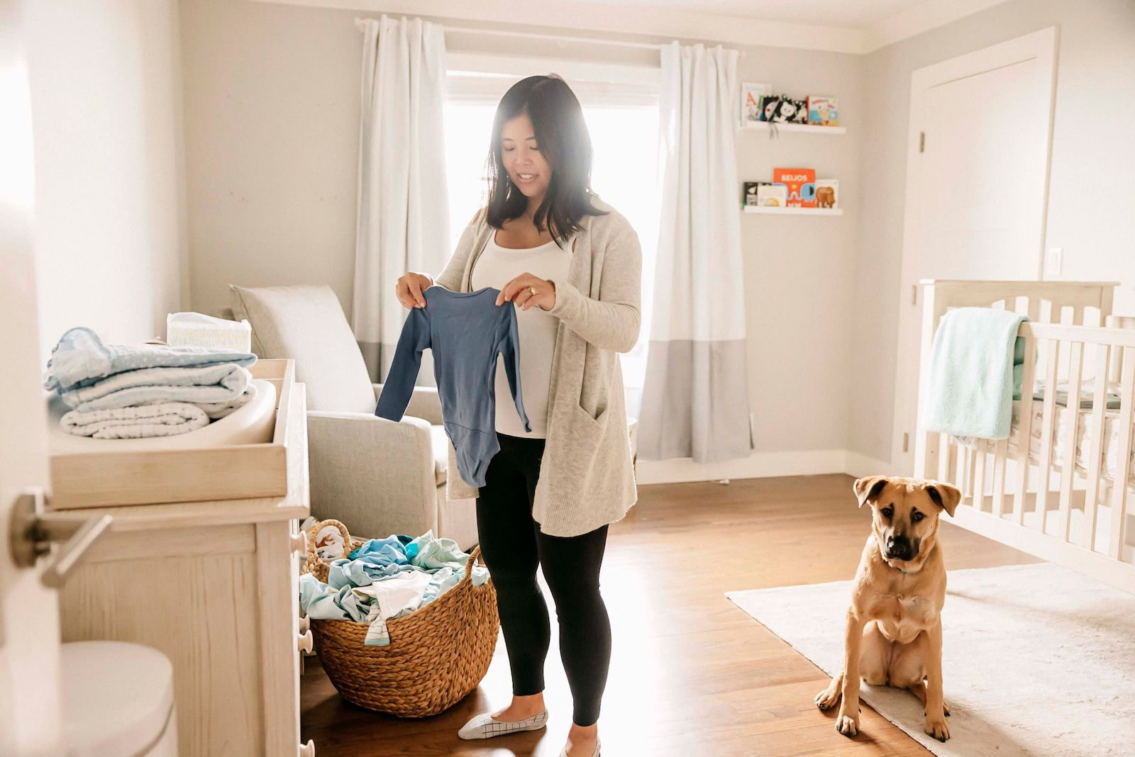 Mother Putting Away Baby Laundry