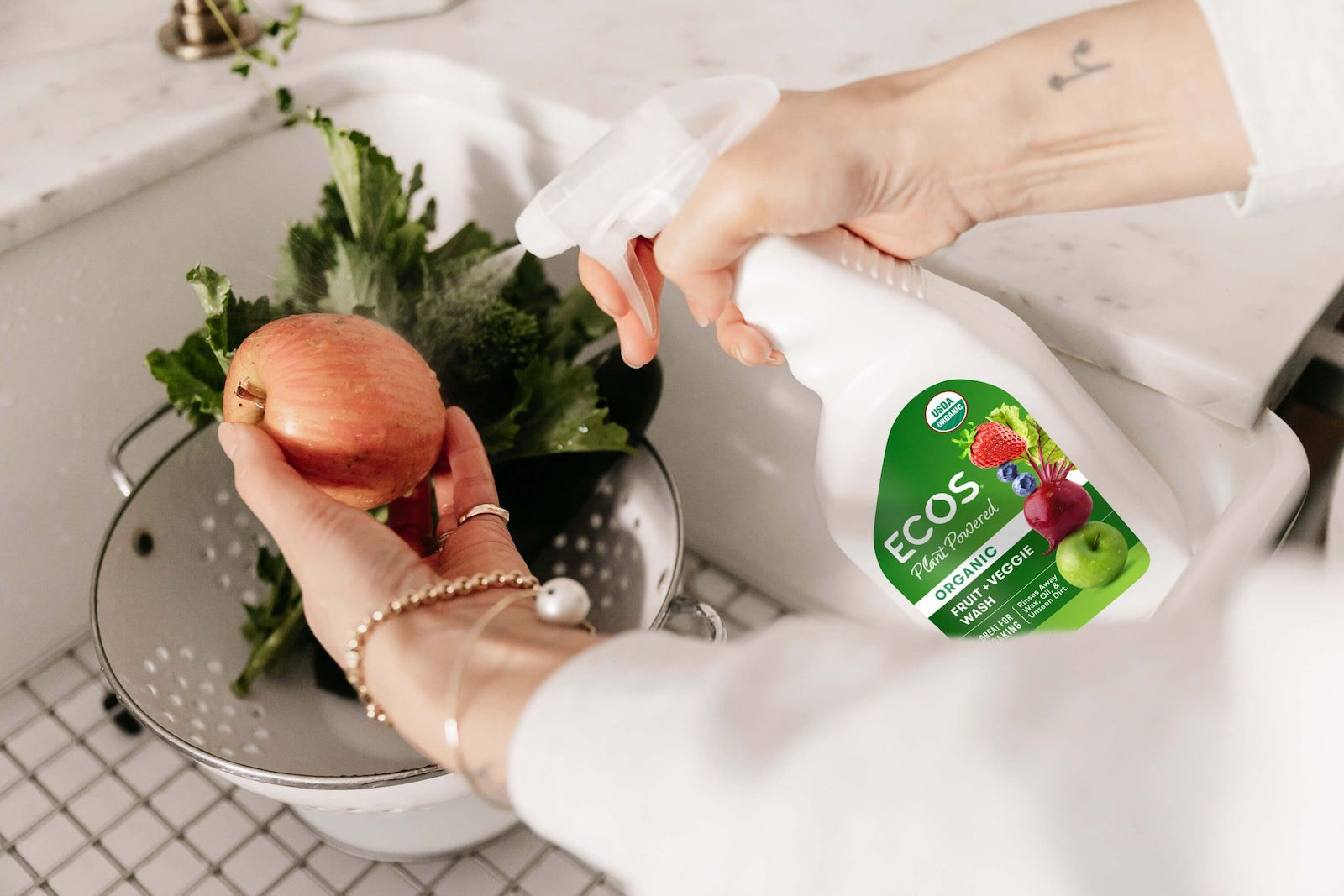 Spraying Produce With Fruit And Veggie Wash